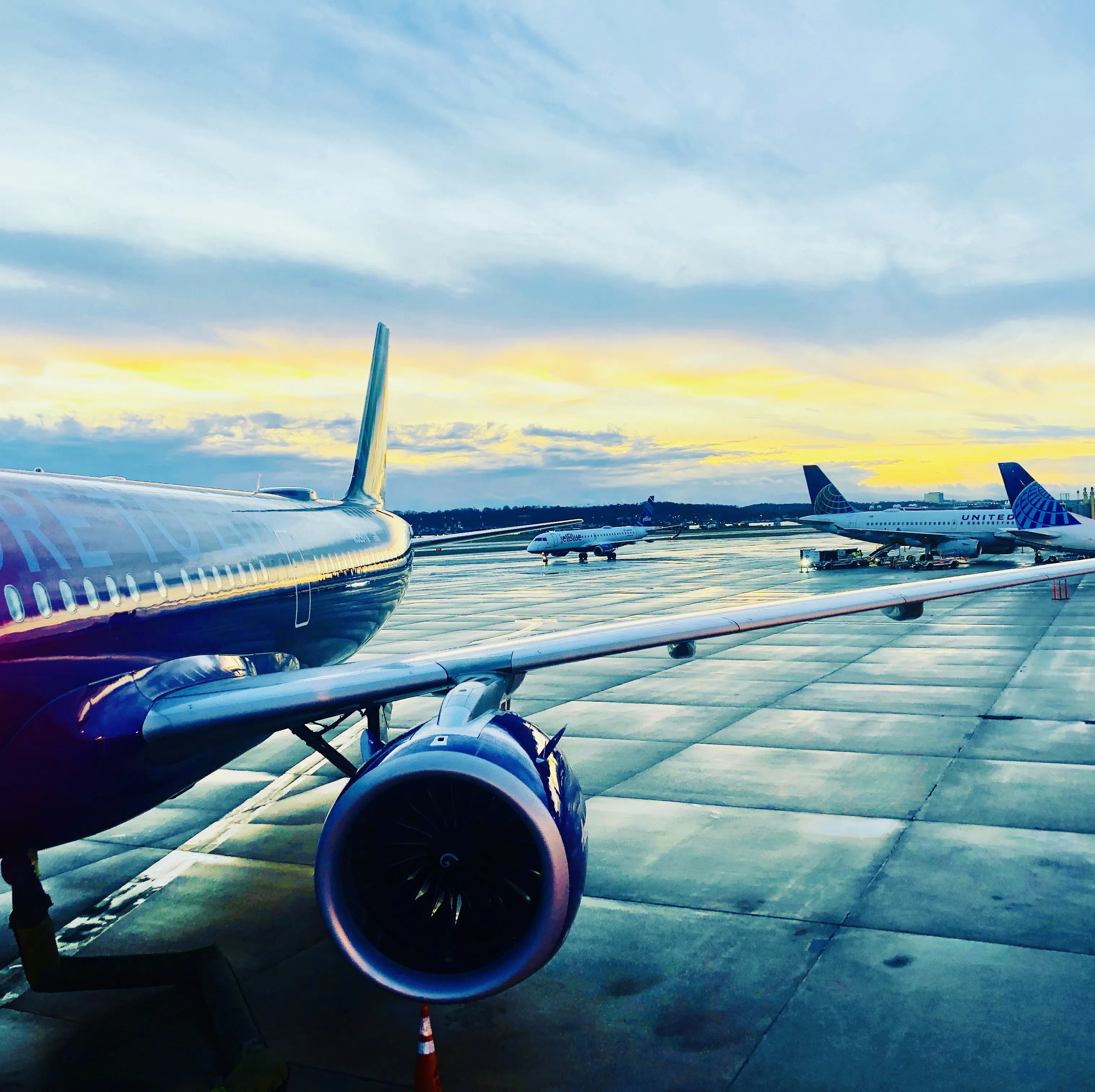 Aircraft parked on an airport apron under an open sky