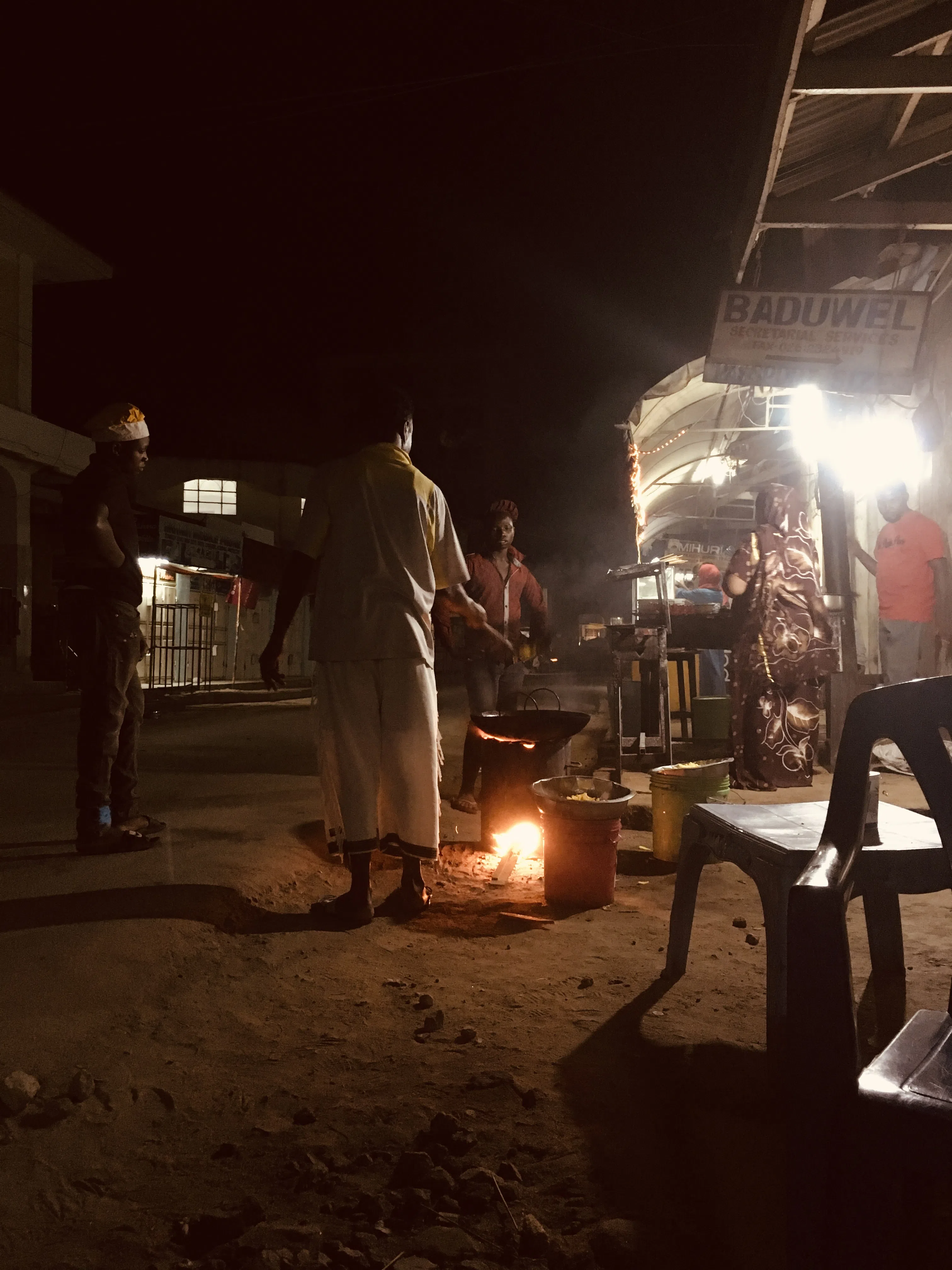 A late-night beachside dining scene lit by warm lights