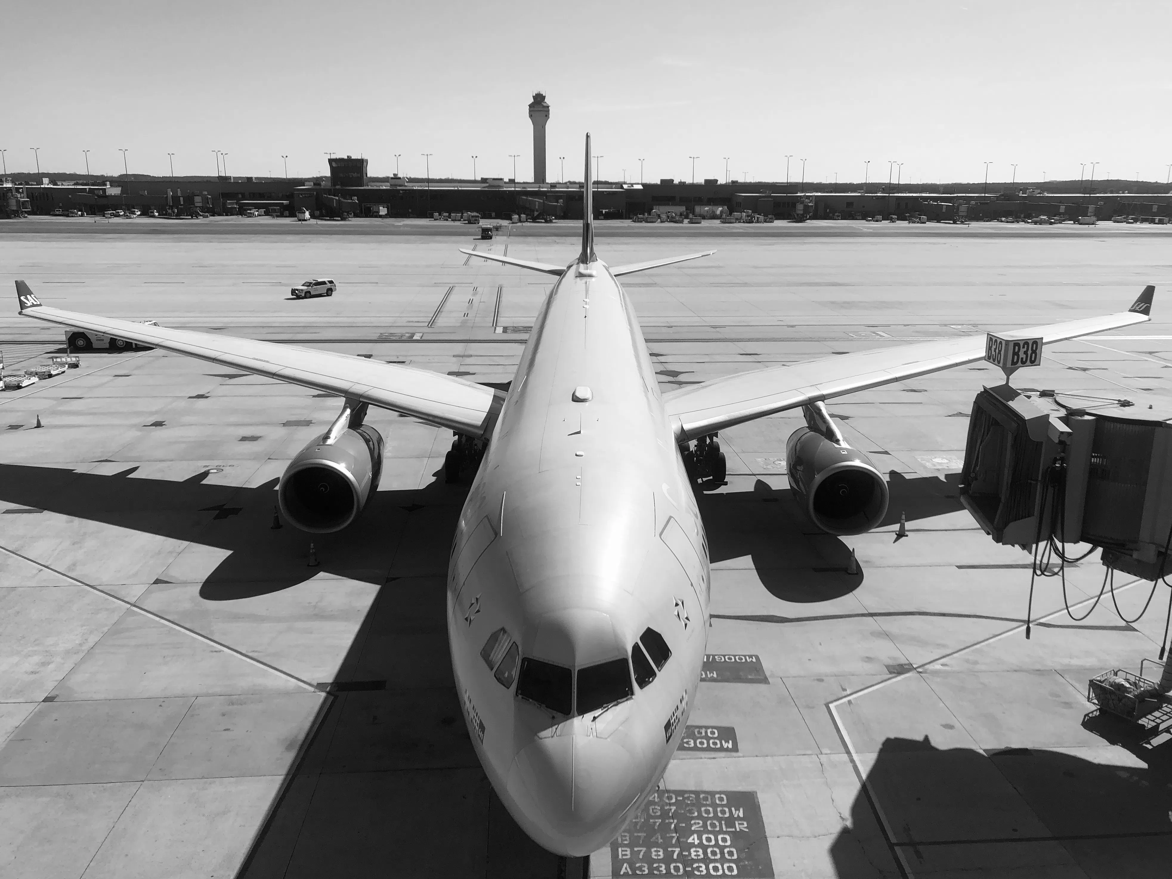 A large passenger aircraft viewed head-on at an airport gate