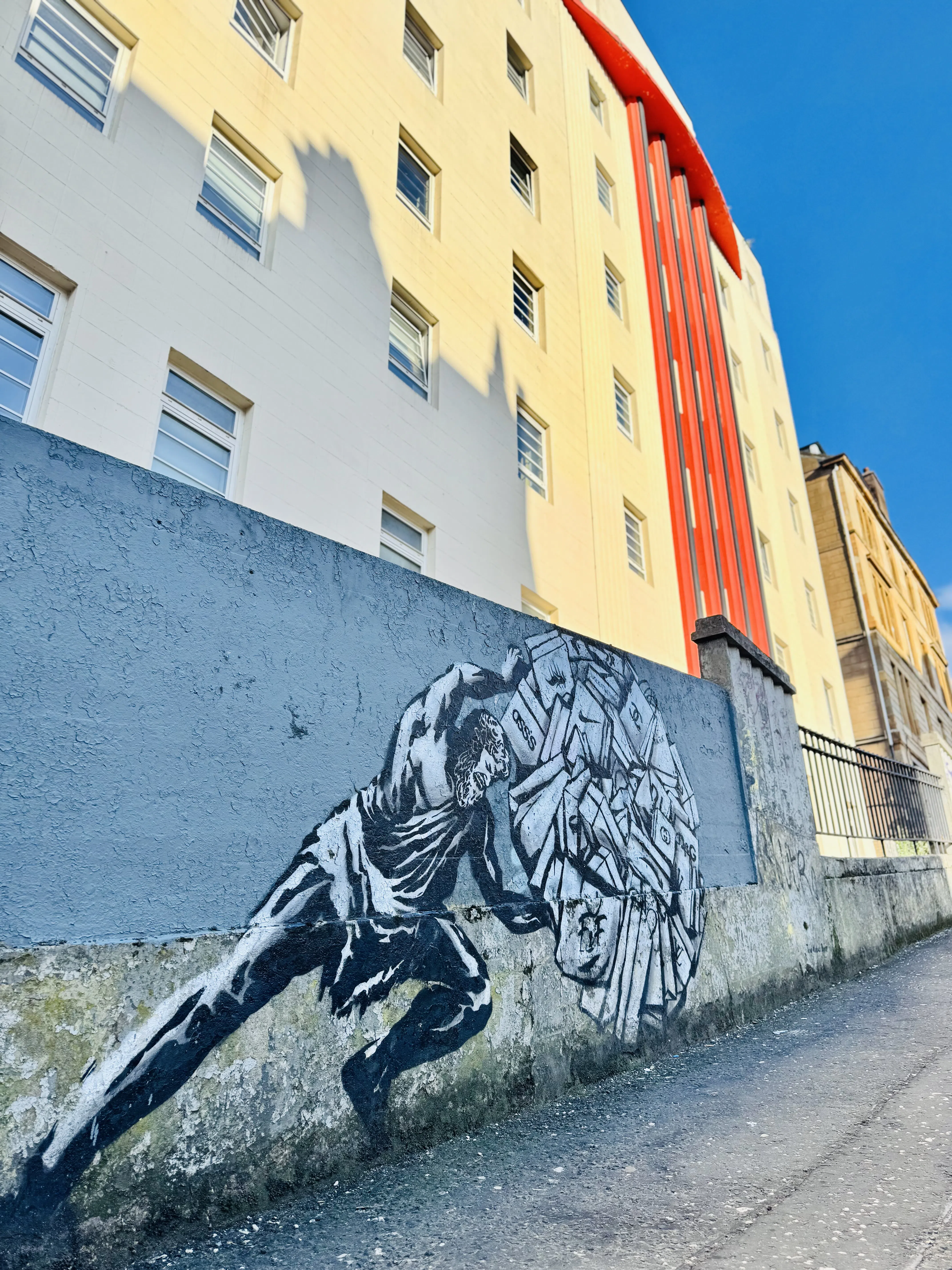 A painted animal mural along a colorful urban wall